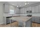 Modern kitchen featuring island with granite countertops, stainless steel appliances, and subway tile backsplash at 5601 Garnet Meadow Rd, Knightdale, NC 27545