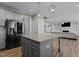 Stylish kitchen island with granite countertop, stainless steel appliances, and modern pendant lighting at 5601 Garnet Meadow Rd, Knightdale, NC 27545
