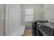 Functional laundry room with washer, dryer, bench and shelving at 5601 Garnet Meadow Rd, Knightdale, NC 27545