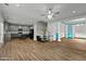 Open-concept living room featuring hardwood floors, modern ceiling fan, and natural light at 5601 Garnet Meadow Rd, Knightdale, NC 27545