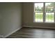 Open bedroom with multiple windows for natural light and hardwood flooring at 5780 Plain View Hwy, Dunn, NC 28334