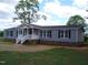 Well-maintained home with gray siding, crisp white trim, and a covered front entry at 5780 Plain View Hwy, Dunn, NC 28334