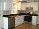 Clean kitchen with white cabinets, stainless steel appliances and black countertops at 5780 Plain View Hwy, Dunn, NC 28334
