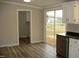 Open kitchen boasts stainless dishwasher and sliding door to deck and backyard at 5780 Plain View Hwy, Dunn, NC 28334