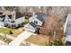 A charming two-story home with an attached garage, mature trees, and a well-manicured front yard at 613 Holly Thorn Trce, Holly Springs, NC 27540