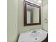 Powder room featuring a vintage style sink and mirror at 613 Holly Thorn Trce, Holly Springs, NC 27540