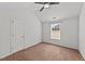 Cozy bedroom featuring a ceiling fan and a window providing natural light at 613 Holly Thorn Trce, Holly Springs, NC 27540