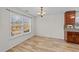 Bright dining area featuring wood floors, a window with a view to a deck, and a hanging light fixture at 613 Holly Thorn Trce, Holly Springs, NC 27540