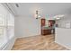 Bright dining area with wood floors and a view into the kitchen at 613 Holly Thorn Trce, Holly Springs, NC 27540