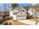 Side view of a two-story home with a two-car garage and a fenced yard at 613 Holly Thorn Trce, Holly Springs, NC 27540