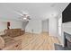 The expansive living room includes a fireplace, wood floors, a ceiling fan, recessed lighting, and two windows at 613 Holly Thorn Trce, Holly Springs, NC 27540
