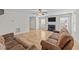 A living room showcasing wood floors, a fireplace, and two windows with a view to the front yard at 613 Holly Thorn Trce, Holly Springs, NC 27540