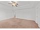 Spacious main bedroom with a tray ceiling, fan, and multiple entryways at 613 Holly Thorn Trce, Holly Springs, NC 27540