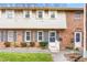 Charming brick townhome with blue shutters, tidy landscaping, and a welcoming entrance at 627 W Front St # C, Burlington, NC 27215