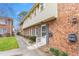 A row of brick townhomes with blue shutters and tidy landscaping, featuring a clean and welcoming sidewalk at 627 W Front St # C, Burlington, NC 27215