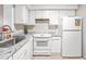 A modern kitchen with white cabinets, stone countertops and stainless steel appliances at 627 W Front St # C, Burlington, NC 27215