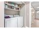 Laundry room with white washer and dryer and plenty of storage on built-in shelving at 627 W Front St # C, Burlington, NC 27215