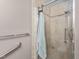 Close-up of beige tiled shower and grab bar, plus towel rack at 627 W Front St # C, Burlington, NC 27215