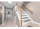 Neutral hallway showcases a wooden staircase leading to the next level of the home at 627 W Front St # C, Burlington, NC 27215