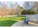 Spacious backyard featuring a lush green lawn, white picket fence, and mature trees, offering privacy and room to play at 6320 Bayswater Trl, Raleigh, NC 27612