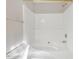Bright white bathtub and shower combination featuring tile surround and sleek fixtures at 706 Canyon Lake Cir, Morrisville, NC 27560