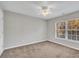 Bedroom with carpeted floors, ceiling fan, and large window at 706 Canyon Lake Cir, Morrisville, NC 27560