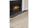 Close up of the fireplace with dark tile border and light hardwood flooring at 706 Canyon Lake Cir, Morrisville, NC 27560
