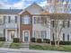Charming townhome exterior with brick accents, manicured lawn, and inviting entry steps at 706 Canyon Lake Cir, Morrisville, NC 27560