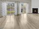 Bright living room featuring hardwood floors, a fireplace and sliding glass doors to backyard at 706 Canyon Lake Cir, Morrisville, NC 27560