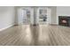 Bright living room featuring hardwood floors, a fireplace and sliding glass doors to backyard at 706 Canyon Lake Cir, Morrisville, NC 27560