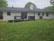 View of backyard featuring a wood deck connected to the home and green grass at 7414 Virgilina Rd, Roxboro, NC 27574
