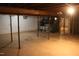 Unfinished basement featuring support beams and white brick walls, with HVAC system at 7414 Virgilina Rd, Roxboro, NC 27574