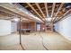 Unfinished basement showing support beams, brick walls and a fireplace at 7414 Virgilina Rd, Roxboro, NC 27574