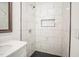 Newly renovated bathroom with tiled walk-in shower, built-in niche, and vanity with modern fixtures at 7414 Virgilina Rd, Roxboro, NC 27574