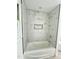 Newly remodeled bathroom features a tiled shower with a built-in niche, and modern fixtures at 7414 Virgilina Rd, Roxboro, NC 27574