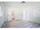 Bright bedroom features new light gray floors, a closet, and a doorway that leads to the bathroom at 7414 Virgilina Rd, Roxboro, NC 27574