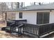 A black deck with black railings outside a white brick house at 7414 Virgilina Rd, Roxboro, NC 27574