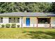 Close-up of a home's blue front door with black shutters and a well-manicured lawn at 7414 Virgilina Rd, Roxboro, NC 27574