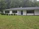 A nice single-story home with a blue door and well-manicured lawn at 7414 Virgilina Rd, Roxboro, NC 27574