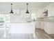 Bright and airy kitchen with large island, pendant lighting, and herring bone backsplash at 7414 Virgilina Rd, Roxboro, NC 27574