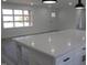 Bright, modern kitchen with white cabinetry and a large center island with a quartz countertop at 7414 Virgilina Rd, Roxboro, NC 27574