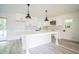 Bright, all-white kitchen with a large island, modern appliances, and stylish backsplash at 7414 Virgilina Rd, Roxboro, NC 27574