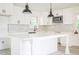 Bright kitchen with white cabinets, a large island, and herring bone tile backsplash at 7414 Virgilina Rd, Roxboro, NC 27574