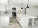 Modern kitchen featuring white cabinets, stainless steel appliances, and an island at 7414 Virgilina Rd, Roxboro, NC 27574