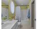 Well-lit bathroom featuring a shower-tub combo and modern vanity at 7850 Silverthread Ln, Raleigh, NC 27617