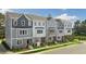 View of newly built gray and white two-story townhomes at Madden West at 813 Washington St, Fuquay Varina, NC 27526