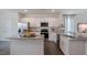 Bright kitchen with stainless steel appliances, white cabinets, and granite countertops at 813 Washington St, Fuquay Varina, NC 27526