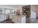 Bright, open kitchen with stainless steel appliances, granite counters, and seamless flow to living area at 813 Washington St, Fuquay Varina, NC 27526