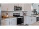 Close-up of a modern kitchen with stainless steel oven, white cabinets, and granite counters at 813 Washington St, Fuquay Varina, NC 27526