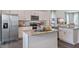 Modern kitchen features stainless steel appliances, white cabinetry, and a granite countertop island at 813 Washington St, Fuquay Varina, NC 27526